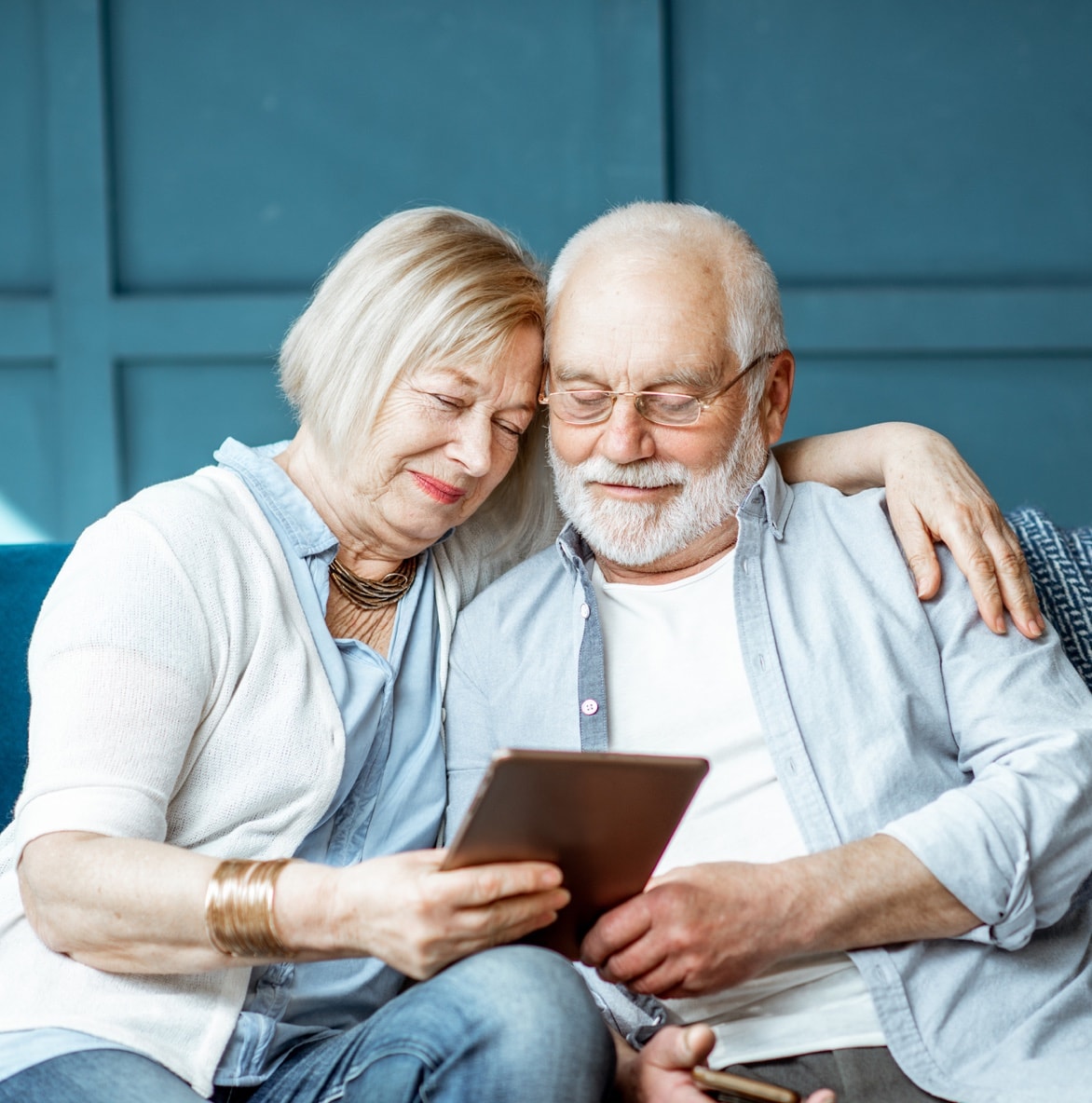Mature couple looks at tablet screen